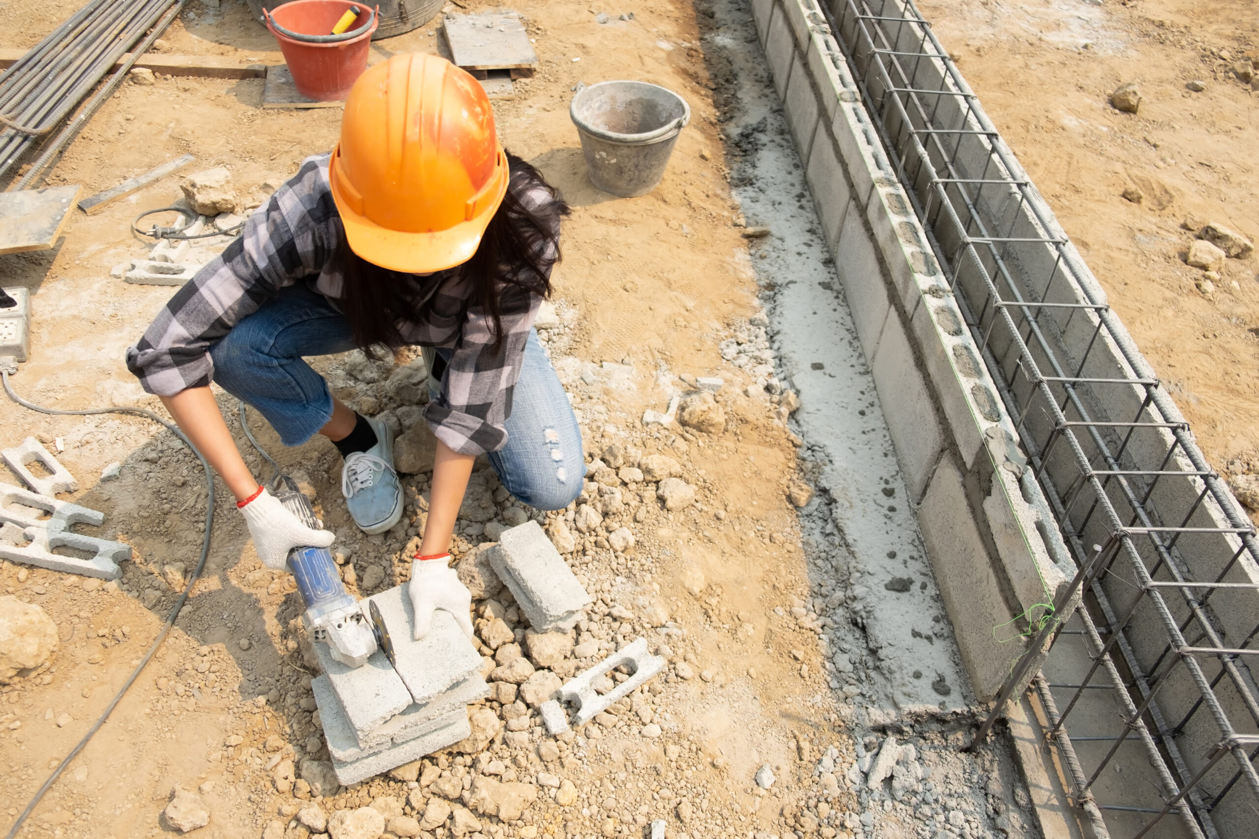 Round saw in the hands of the Builder, work on laying paving slabs. Working saws, cuts paving slab